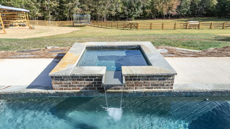 A swimming pool with a hot tub in the middle of it.