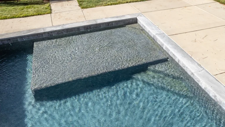A close up of a swimming pool with steps leading into it.